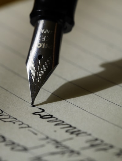 fountain pen on black lined paper