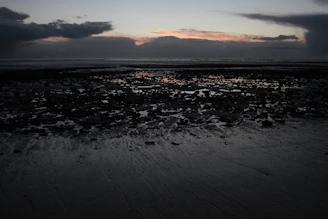 A moody beach scene on Texel at sunset, reflecting Jesse's badboy vibe.