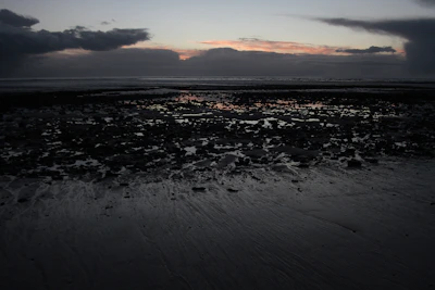 A moody beach scene on Texel at sunset, reflecting Jesse's badboy vibe.