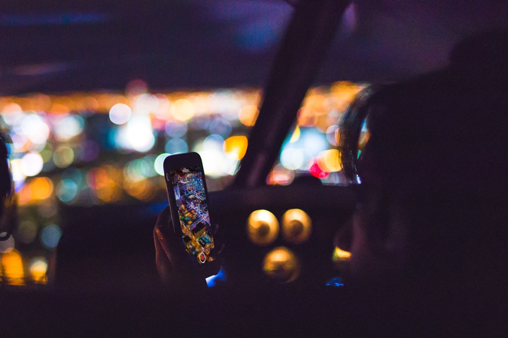 person using Android smartphone inside car