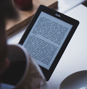 turned on black Amazon Kindle e-book reader