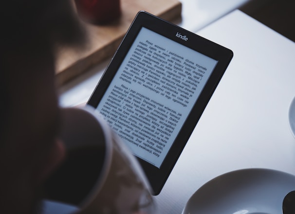 turned on black Amazon Kindle e-book reader