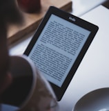 turned on black Amazon Kindle e-book reader