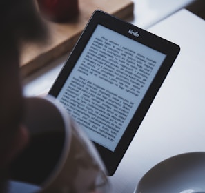 turned on black Amazon Kindle e-book reader