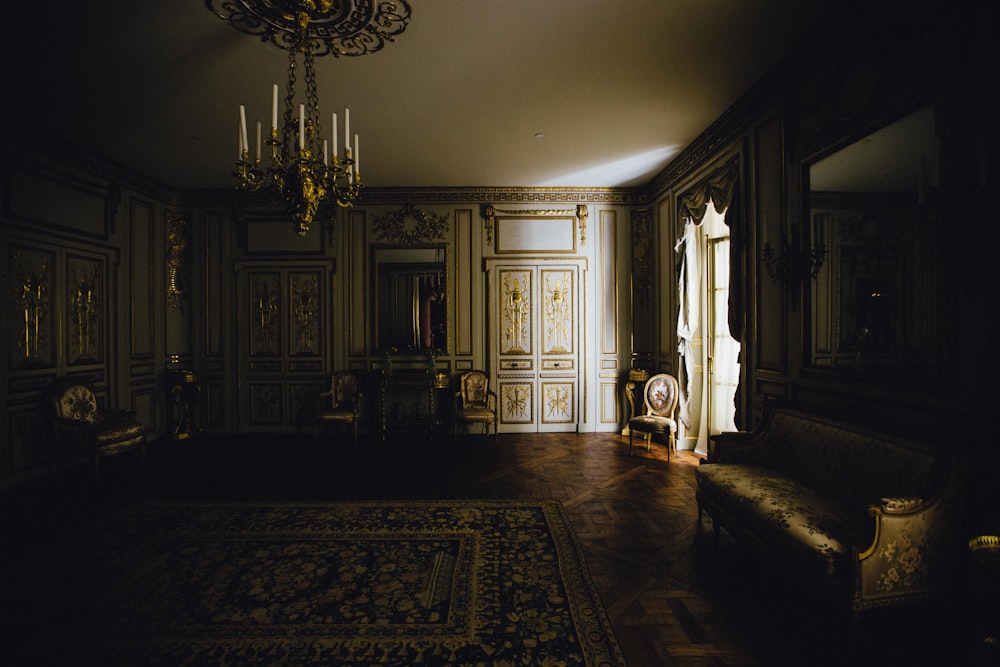 a living room with a couch and a chandelier