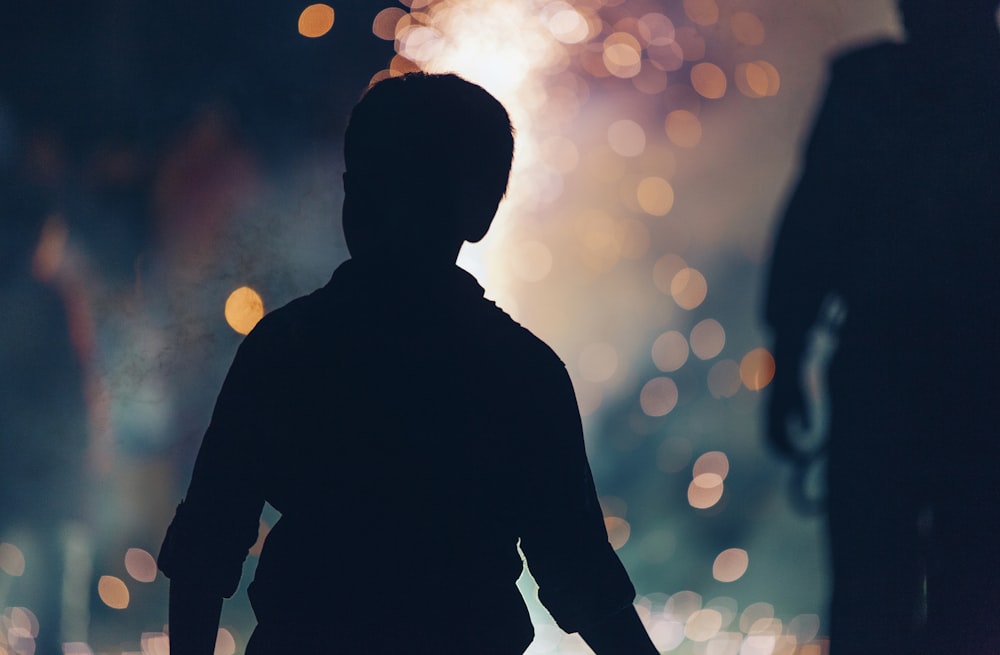 silhouette photography of boy beside woman