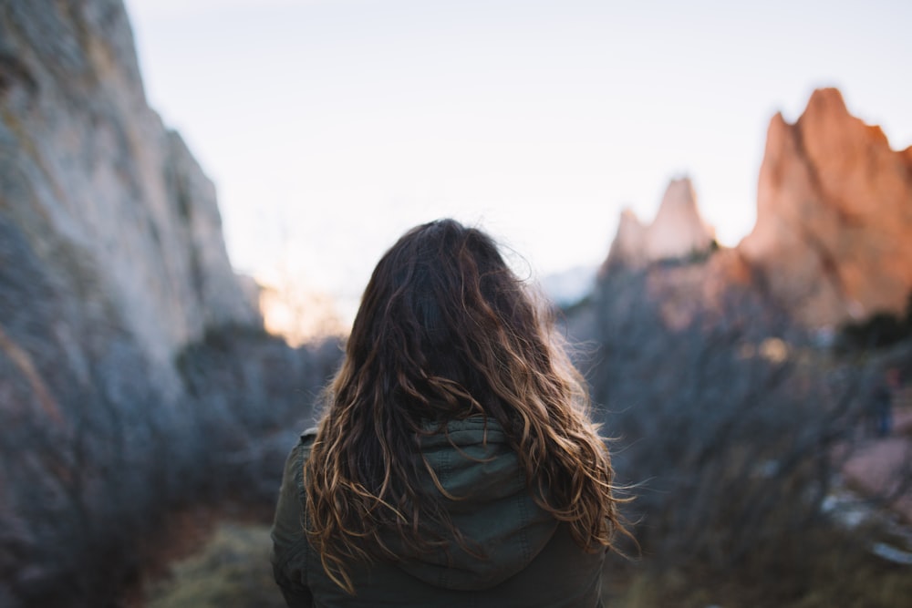 woman facing mountains at daytime