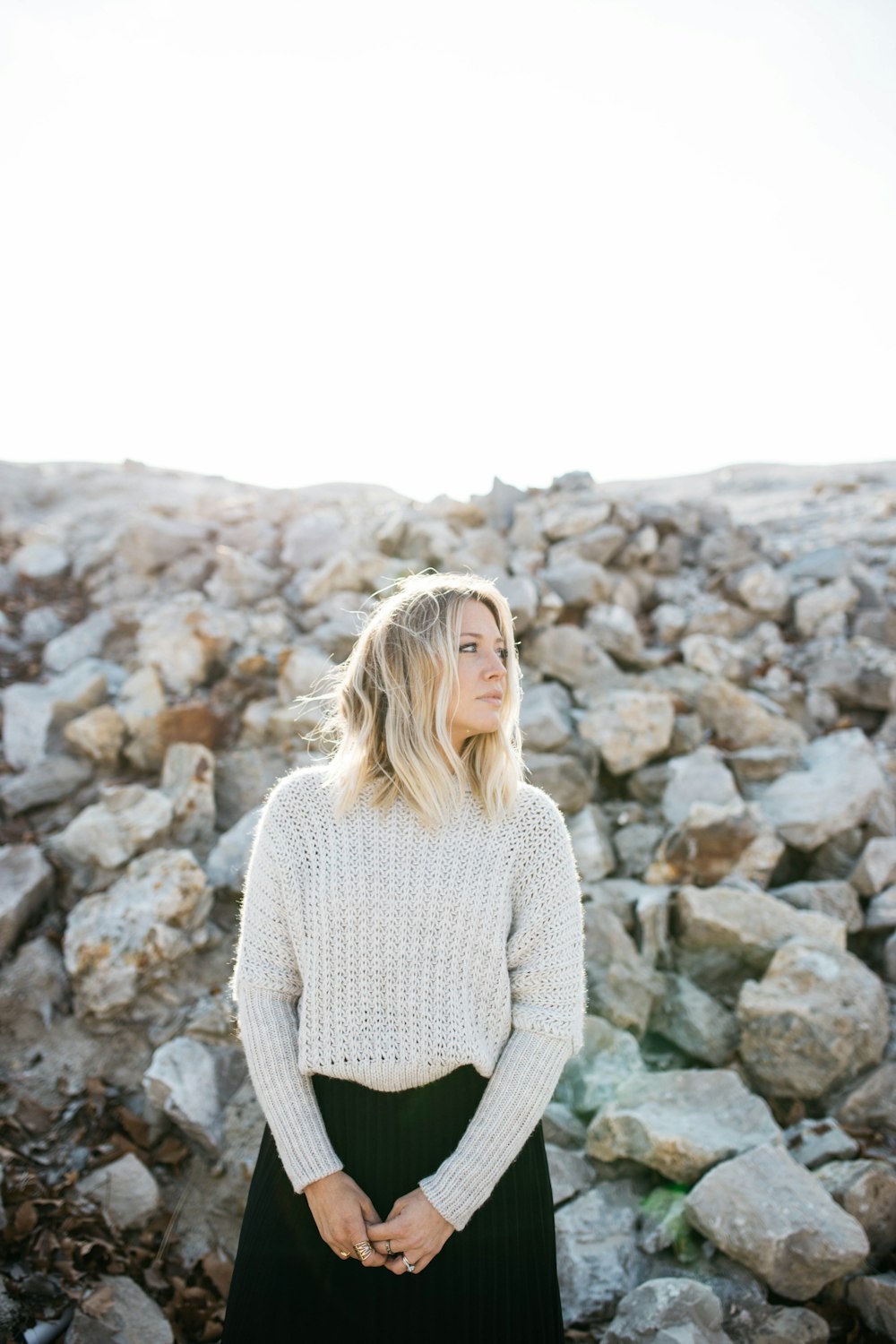 woman in gray sweater and black skirt