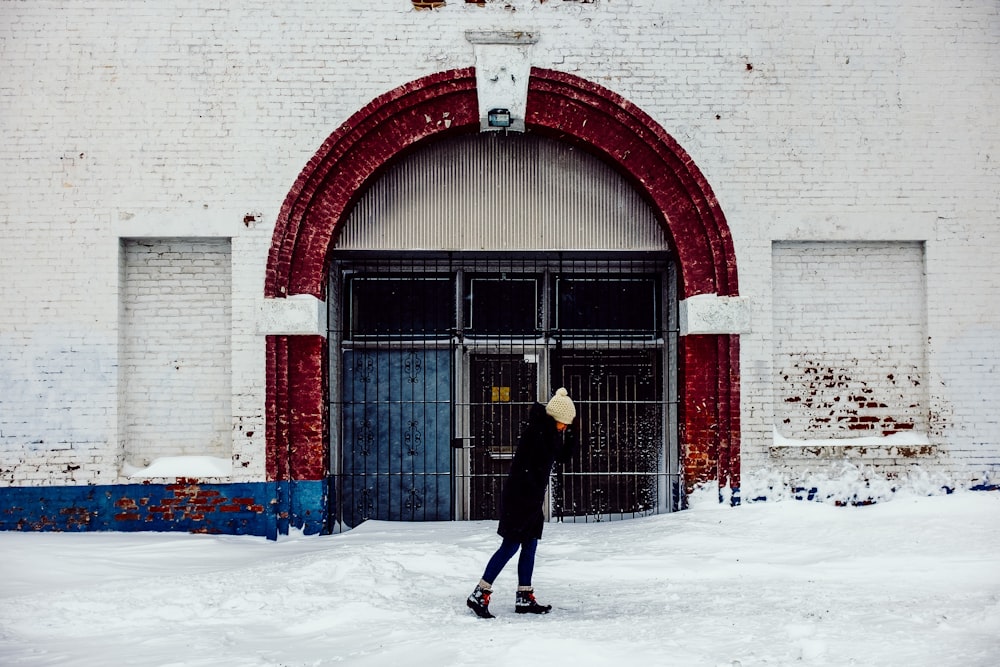 woman standing in front of white concrete building