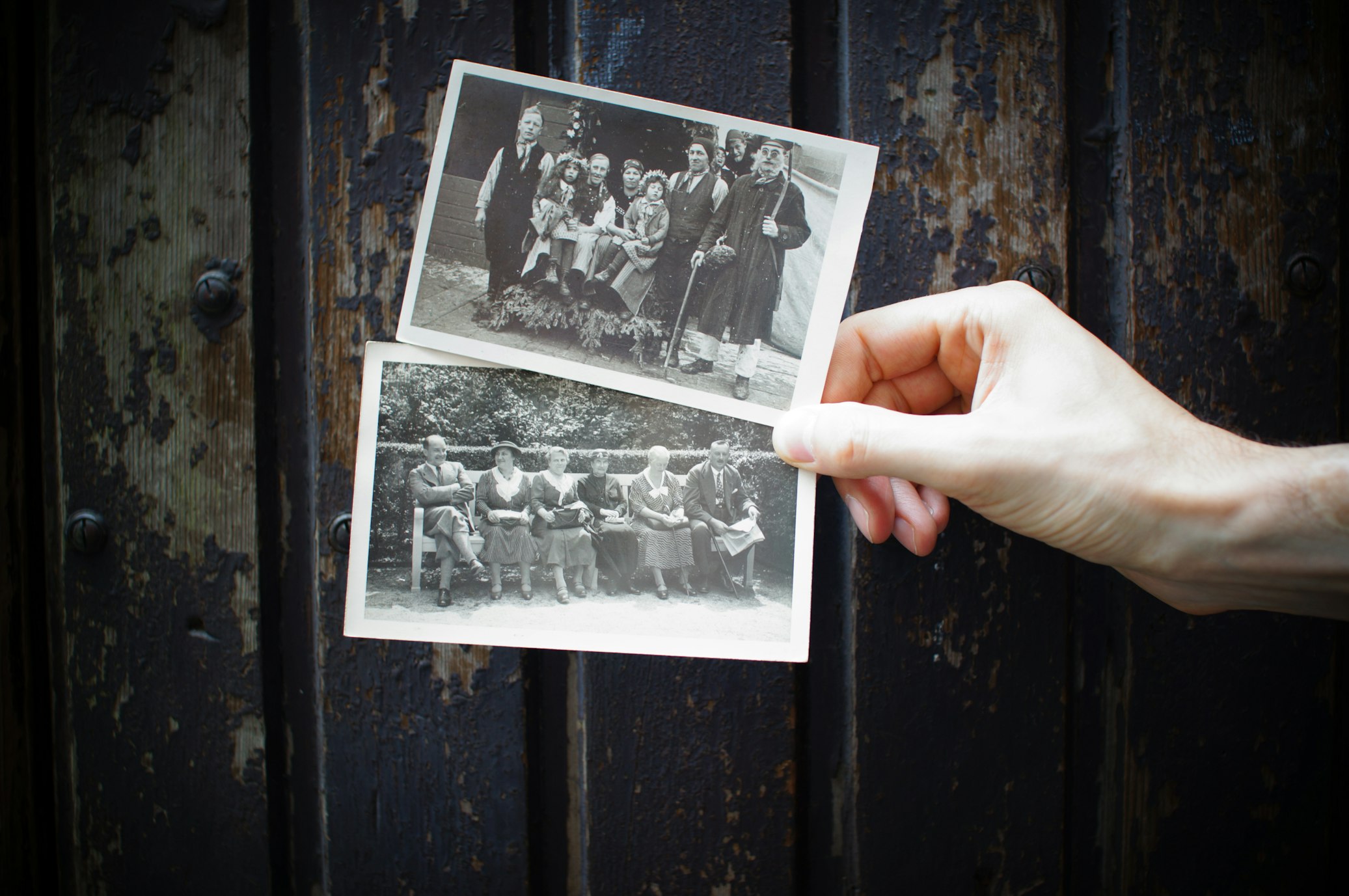 Person holding vintage photos