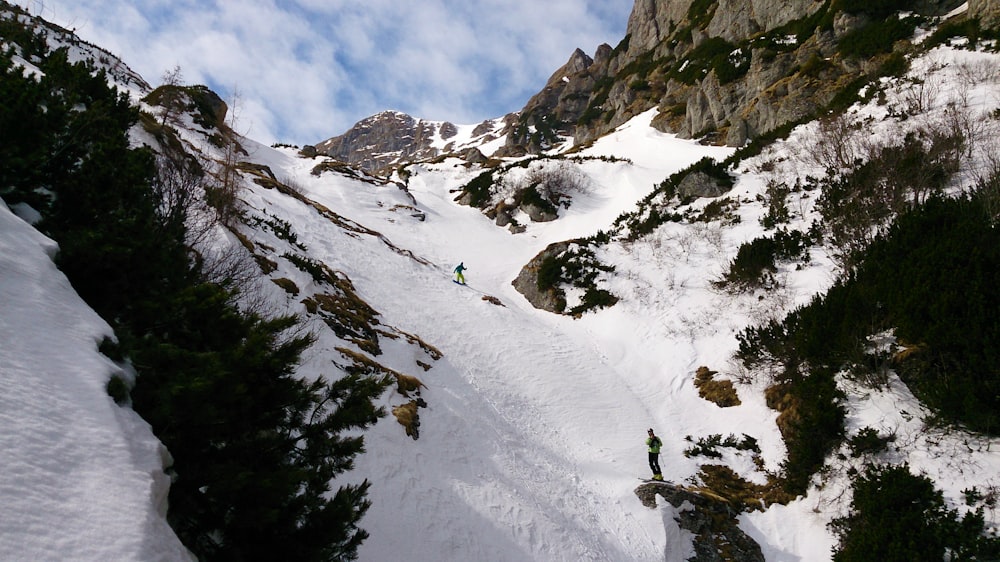 person snowboarding on mountain covered with snow