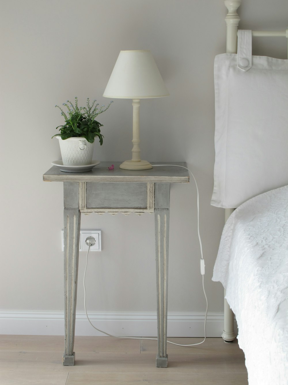 white table lamp on gray end table