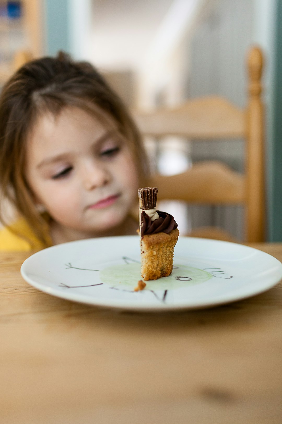 girl staring at the cake on plate