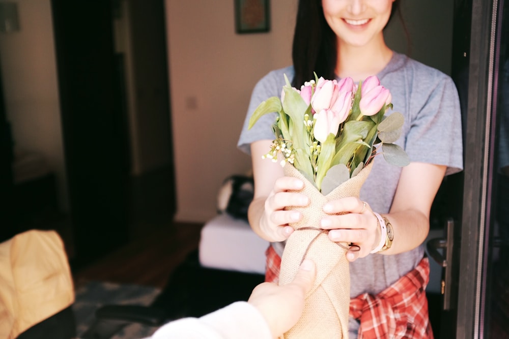 woman holding flower bouquets