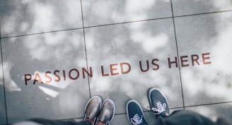 two person standing on gray tile paving