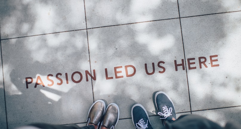 two person standing on gray tile paving