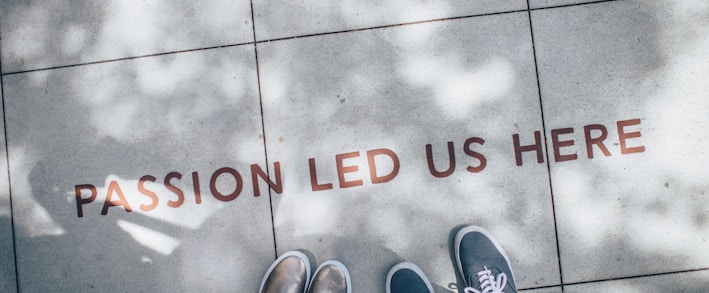 two person standing on gray tile paving