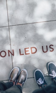 two person standing on gray tile paving