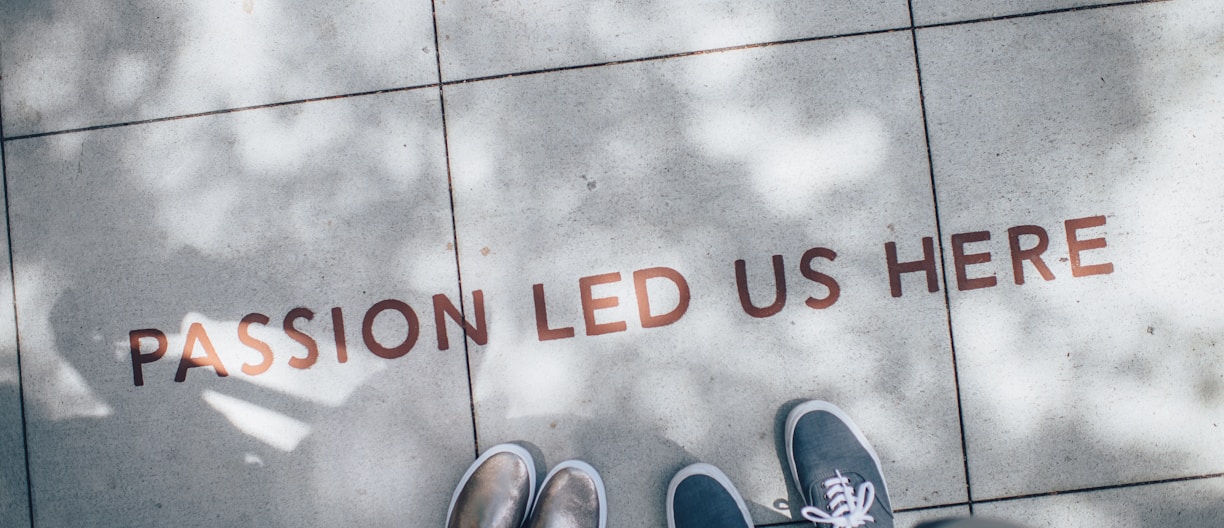 two person standing on gray tile paving