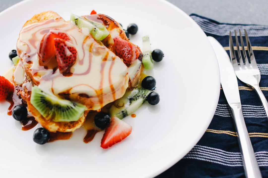 plate of pancake with strawberry and kiwi toppings, Gourmet French Toast