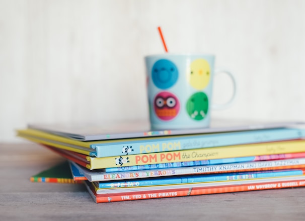 A colorful stack of children's storybooks with playful illustrations.