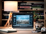 MacBook Pro on brown wooden table inside room