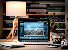 MacBook Pro on brown wooden table inside room