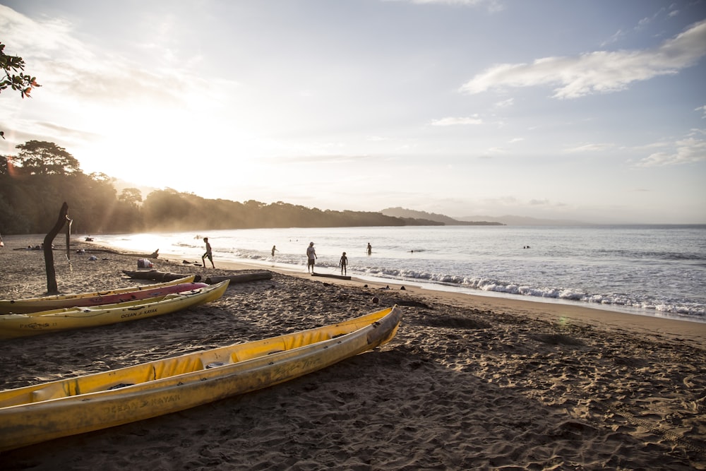 yellow and white boat on beach during daytime