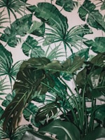 A vibrant tropical monotype featuring bold leaf patterns in rich greens and yellows.