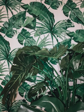 A vibrant tropical monotype featuring bold leaf patterns in rich greens and yellows.