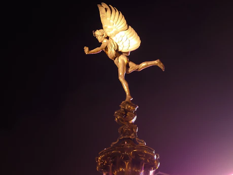 A sleek golden winged sandal resting on an ancient scroll, symbolizing Hermes' swift message delivery.