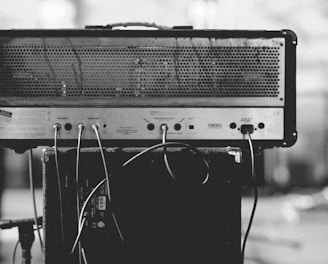 gray and black amplifier on speaker