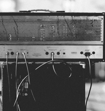 gray and black amplifier on speaker