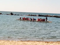 President Tom Joseph speaking passionately at a community dragon boat event.