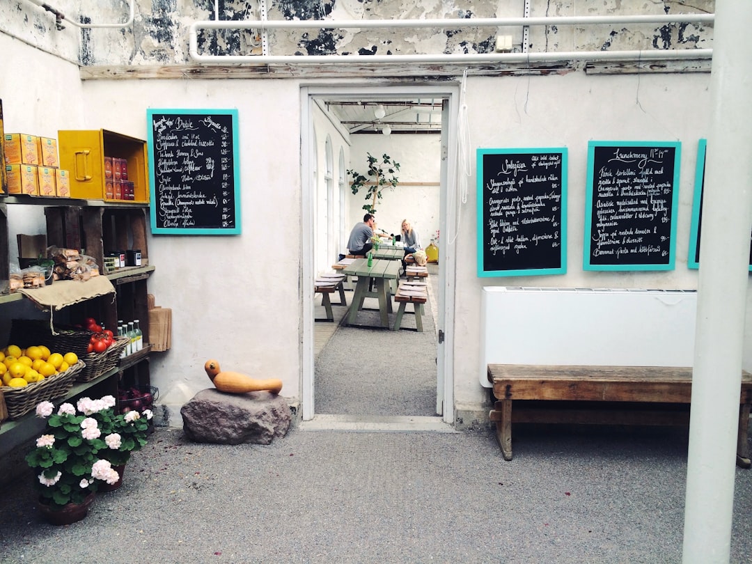 man and woman sitting on bench inside white room, Trendy Cafe
