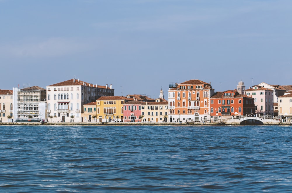 concrete houses and bridge near body of water