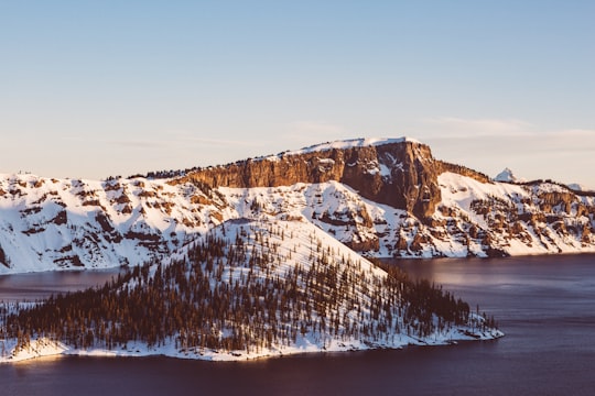 snow covered islet at daytime in Crater Lake National Park United States