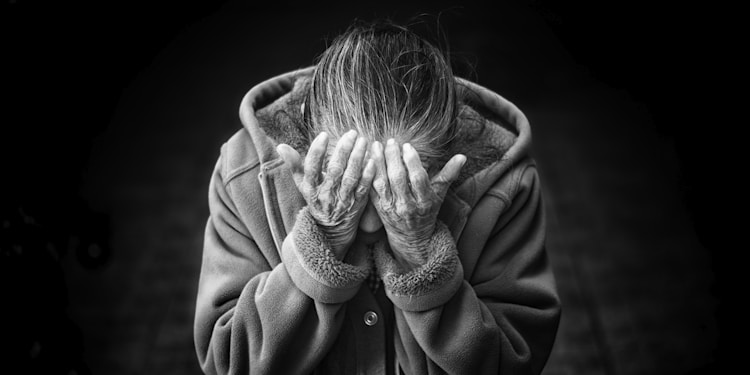 grayscale photography of person covering face