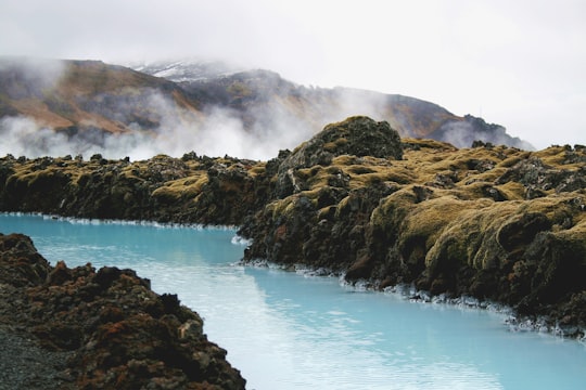 landscape photography of river in the middle of mountains in Blue Lagoon Iceland
