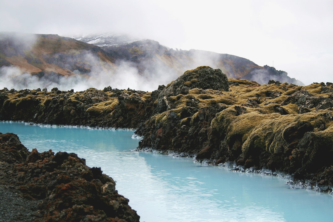landscape photography of river in the middle of mountains, Misty Blue Lagoon