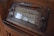 A vintage radio with a classic design featuring a large tuning dial and various frequency numbers. The radio has a wooden casing and multiple control knobs. It displays a variety of international radio stations, indicative of its age and style.