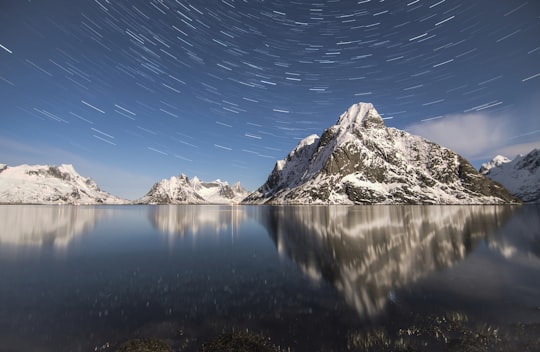 timelapse photography of mountain alps near water with stars in Reine Norway