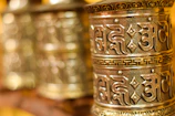 An elegant brass vastu yantra with intricate engravings displayed against a soft fabric background.