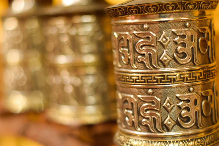 A close-up of a shining brass yantra resting on a wooden table with soft sunlight highlighting its intricate patterns.