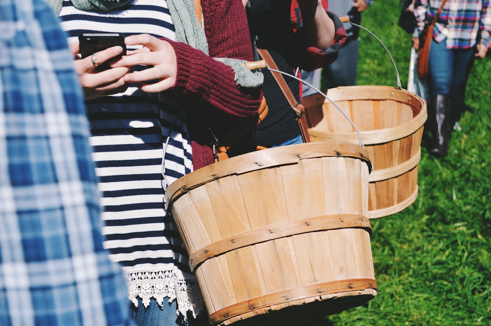 two person fall in line while holding basket