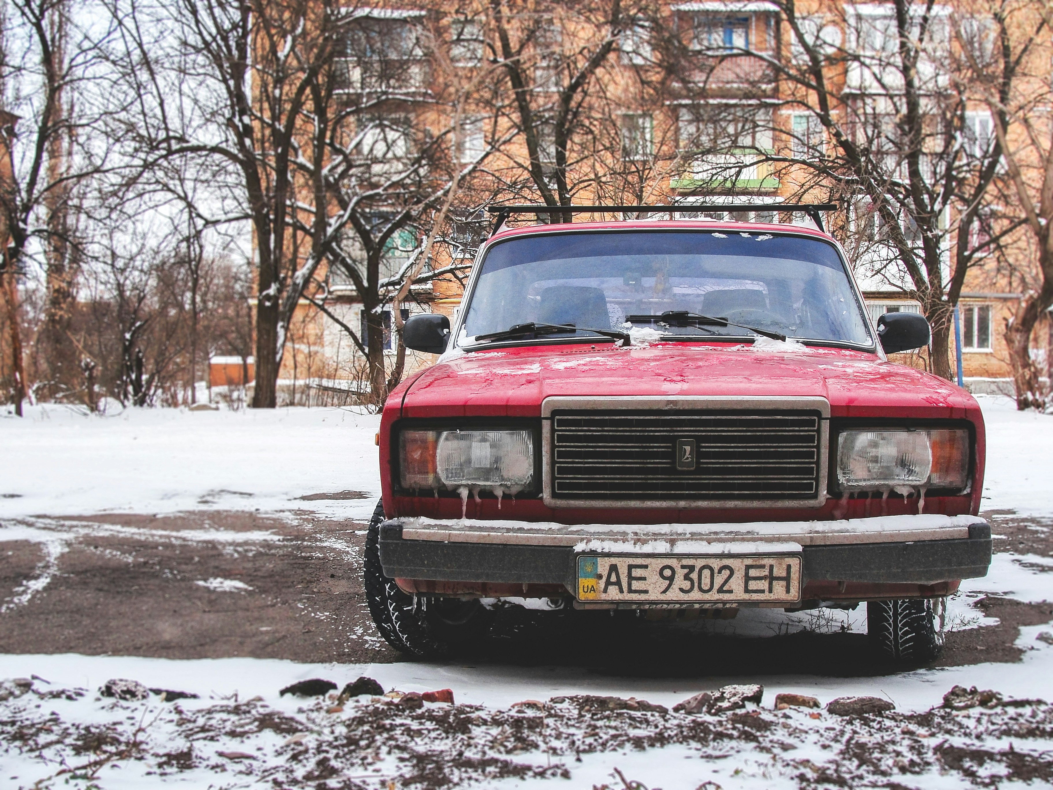 Red car in a snowy lot