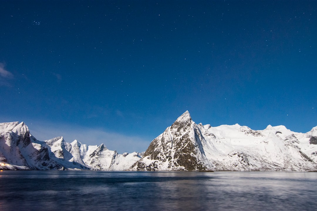 lake near mountain covered with snow