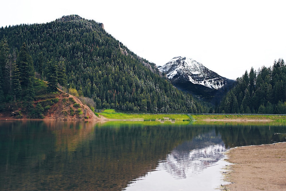 photo of mountain near river at daytime