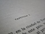 A close-up of a printed PDF file titled 'Doctrinas' on a wooden desk.