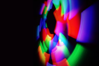 A mesmerizing display of vibrant, swirling lights in various colors against a dark background, creating a dynamic and abstract visual effect.
